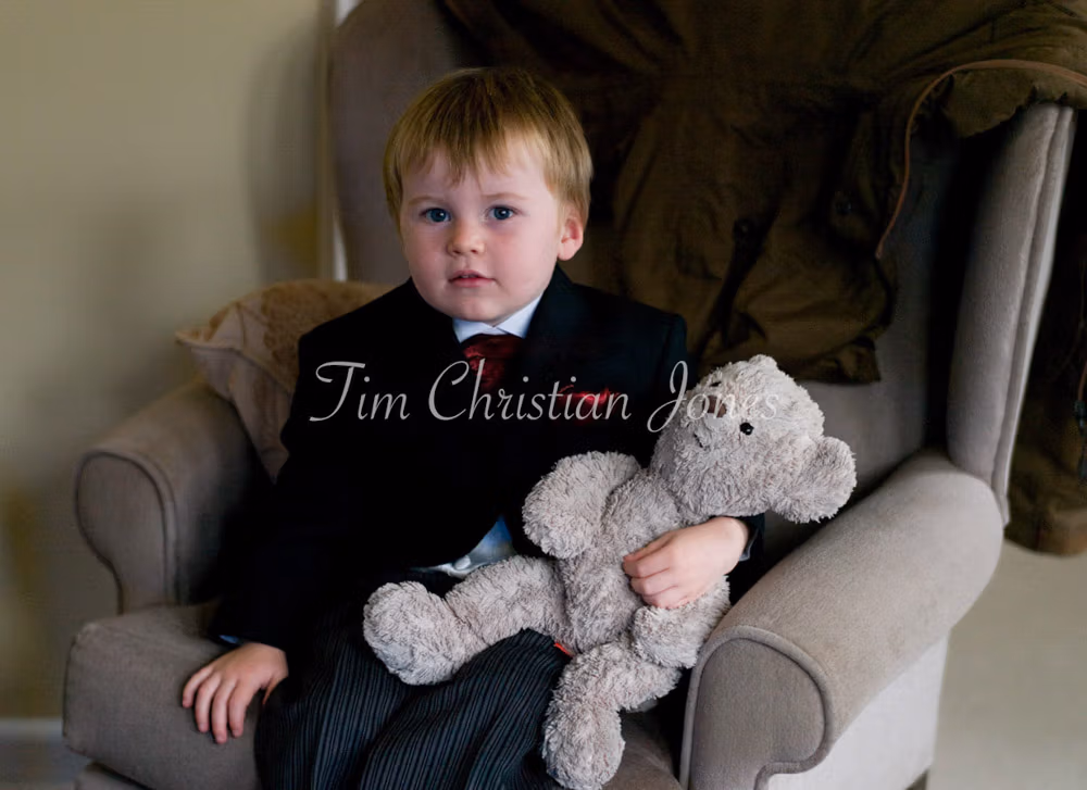 Pageboy sat with his teddy bear