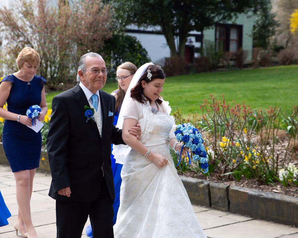 Close-up of father and daughter as he walks her to the Minster