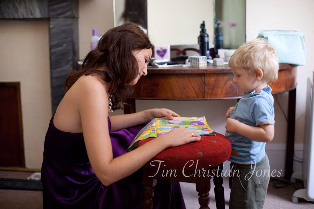 Bride’s sister and young son reading together before the ceremony at Stourton's Temple of Apollo
