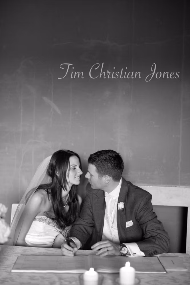 Bride and groom close together, gazing into each other’s eyes in black and white