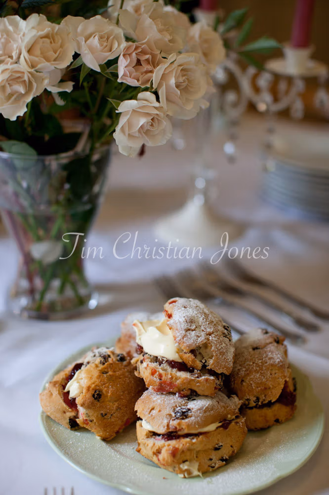 Wedding breakfast detail shot: scones with jam and cream, served at a summer tea