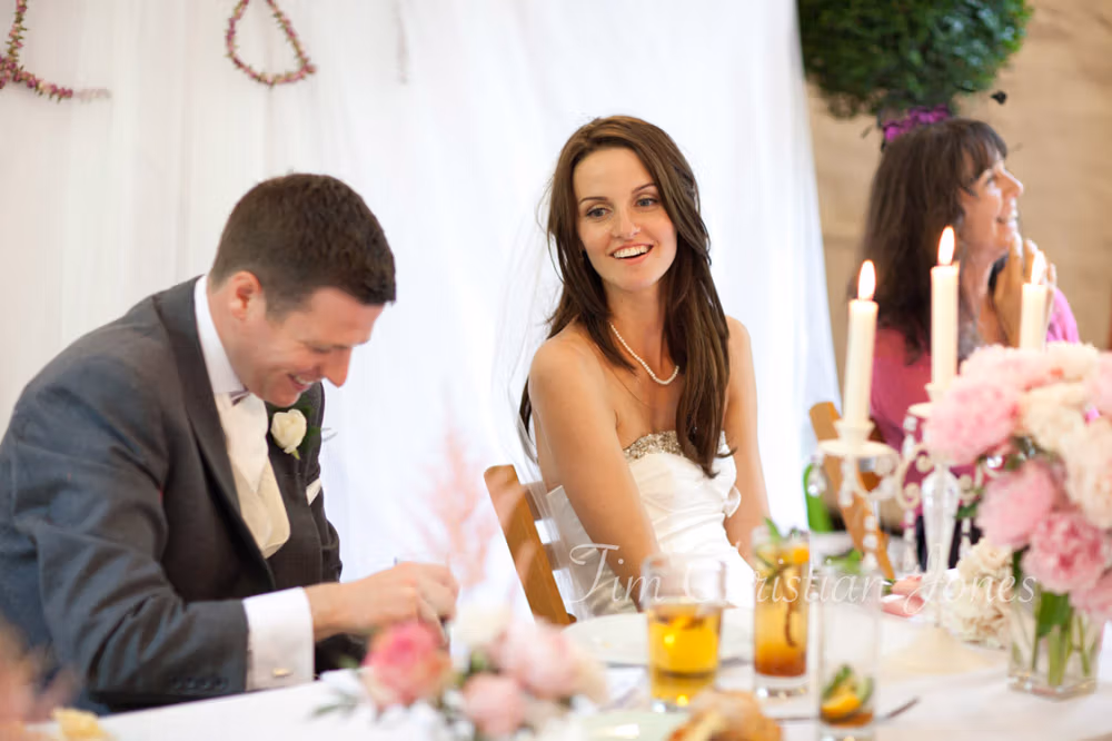 The groom laughing during the best man’s speech