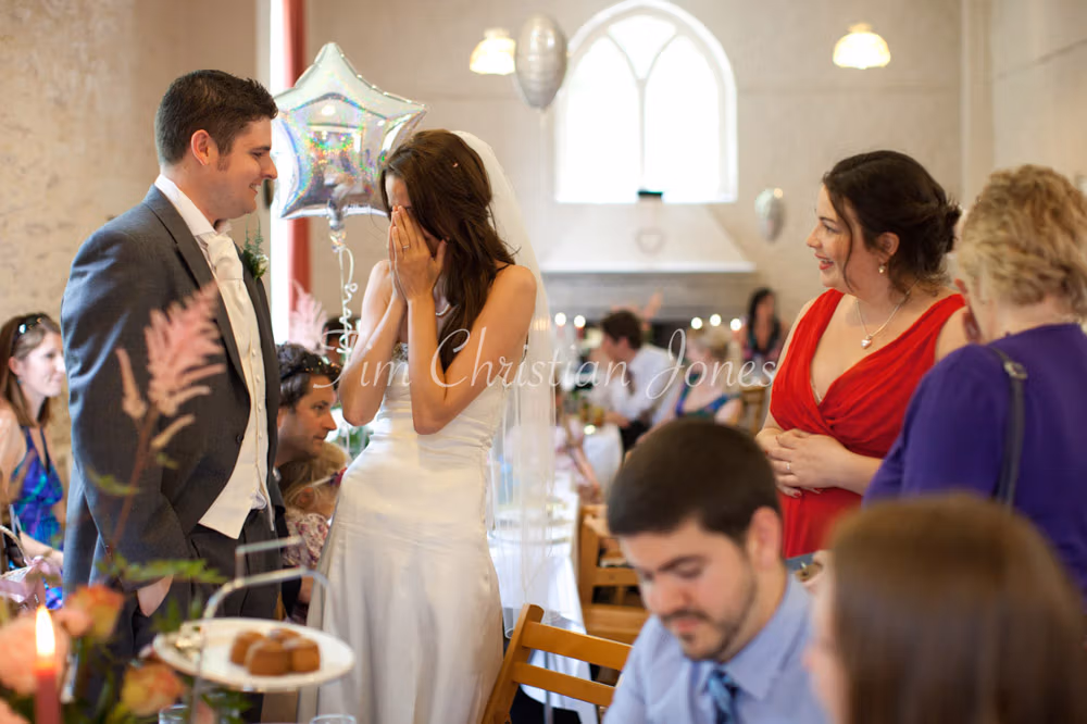 Lowri speaking with the best man while others smile around them